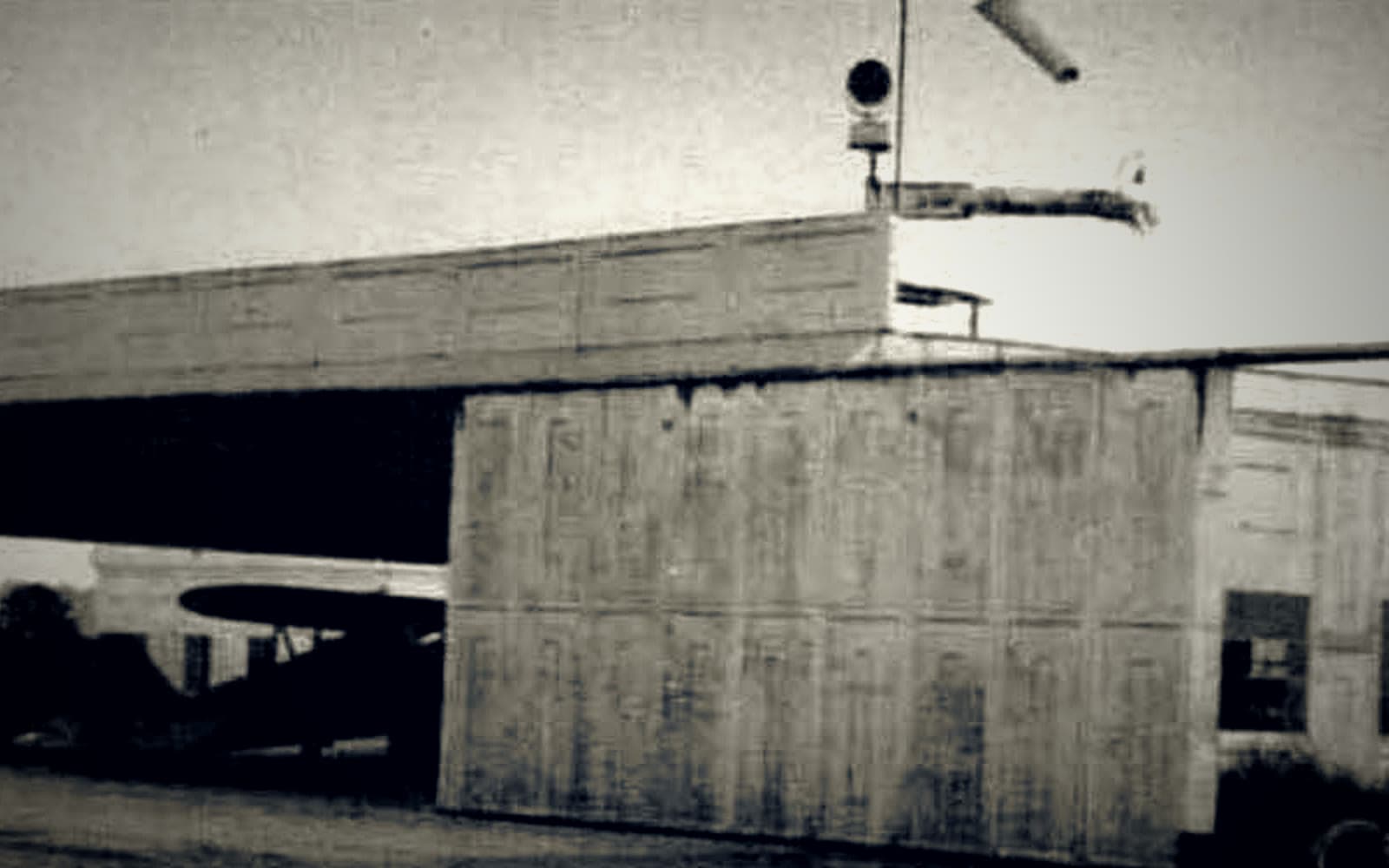 Historic 1940 R.G. LeTourneau hangar at Toccoa-Stephens County Airport, with an aircraft visible in the open bay.