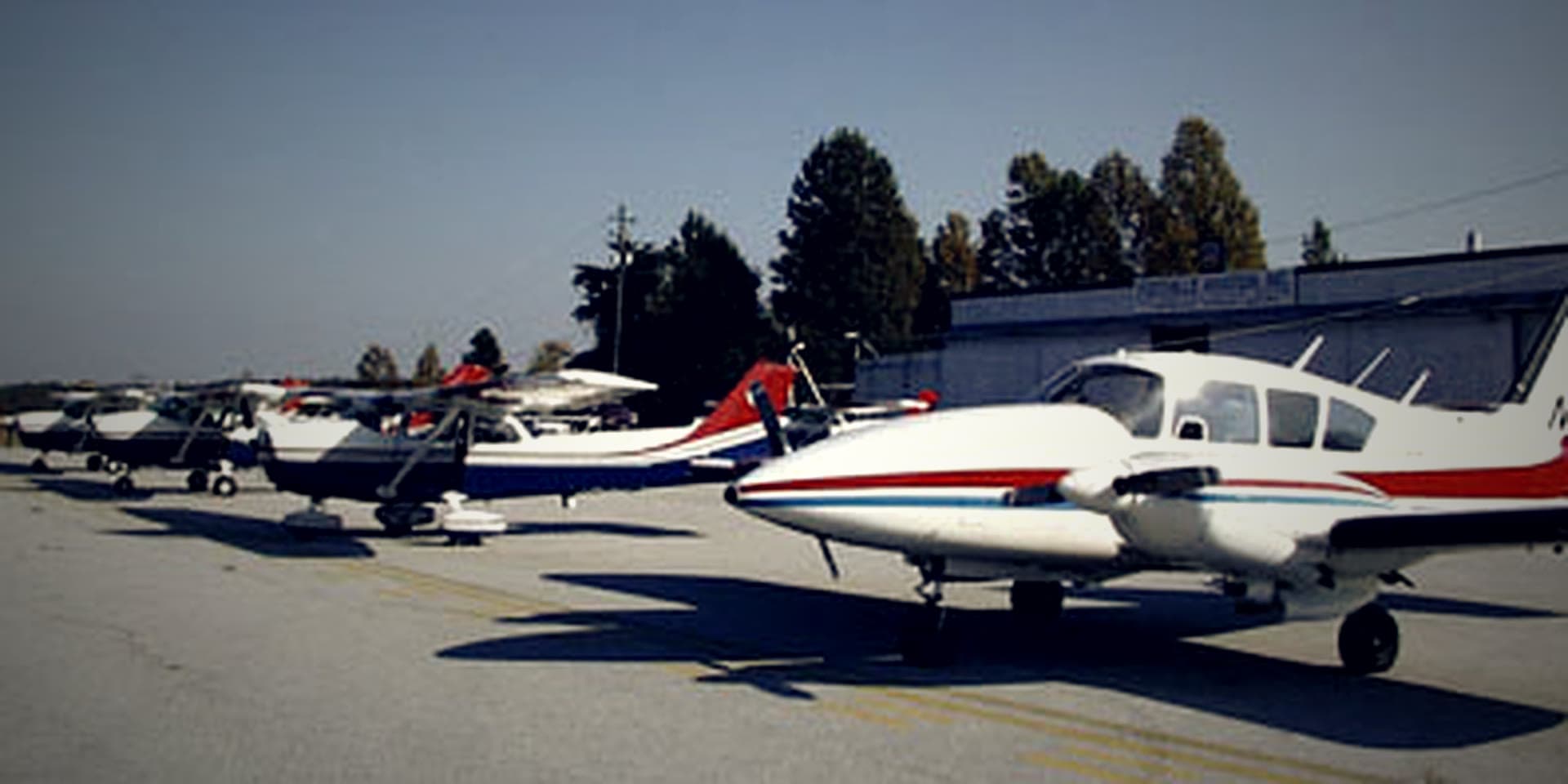 General aviation aircraft on the ramp in front of the signed Foothills Aviation, Inc. building at Toccoa-Stephens County Airport.